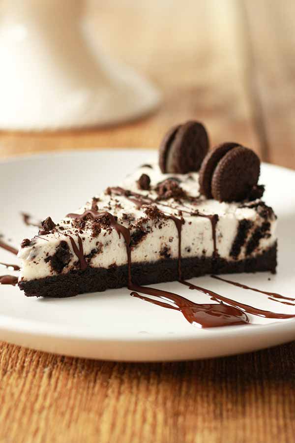 slice of Oreo Cheesecake on a white plate