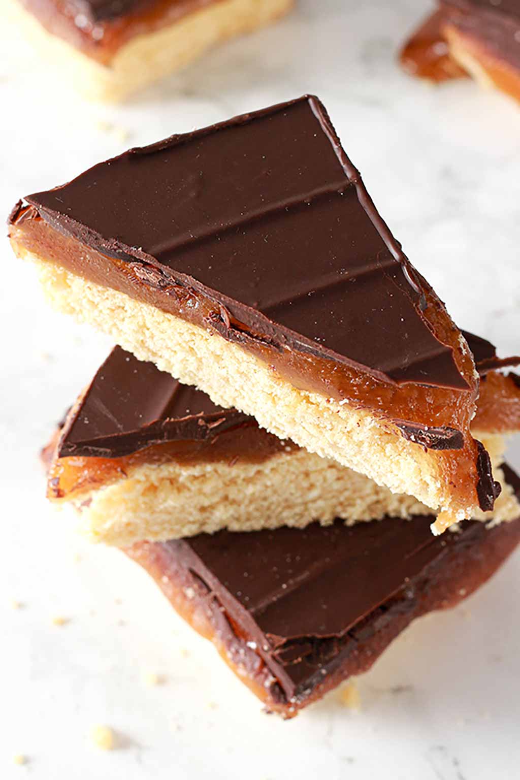 stack of 3 triangles of vegan millionaire shortbread