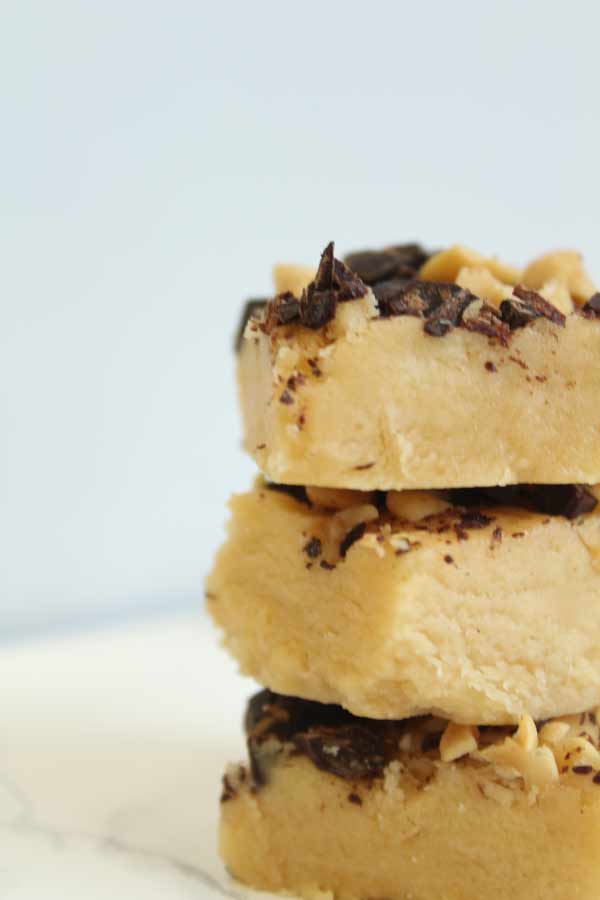 3 pieces of 3 ingredient peanut butter fudge stacked on top of one another