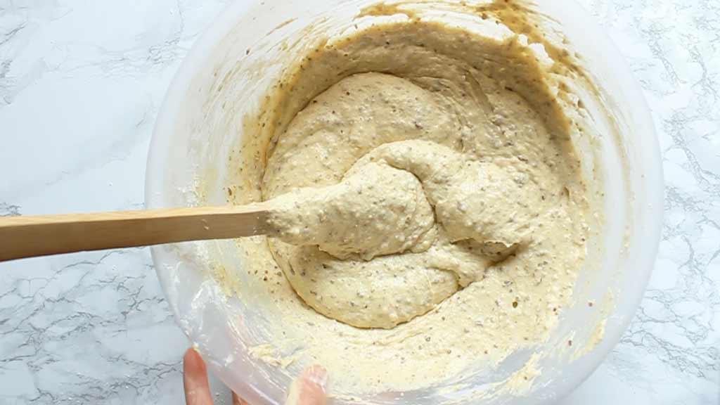 cake batter in a bowl with a wooden spoon in