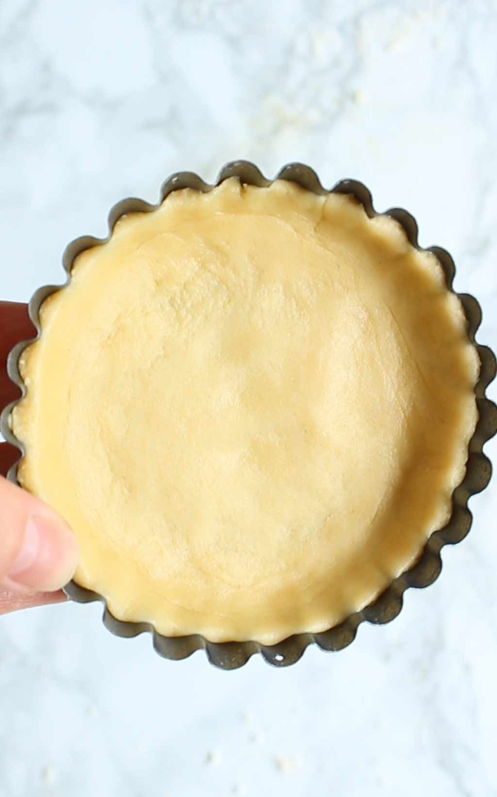 dough pressed into a mini tart tin