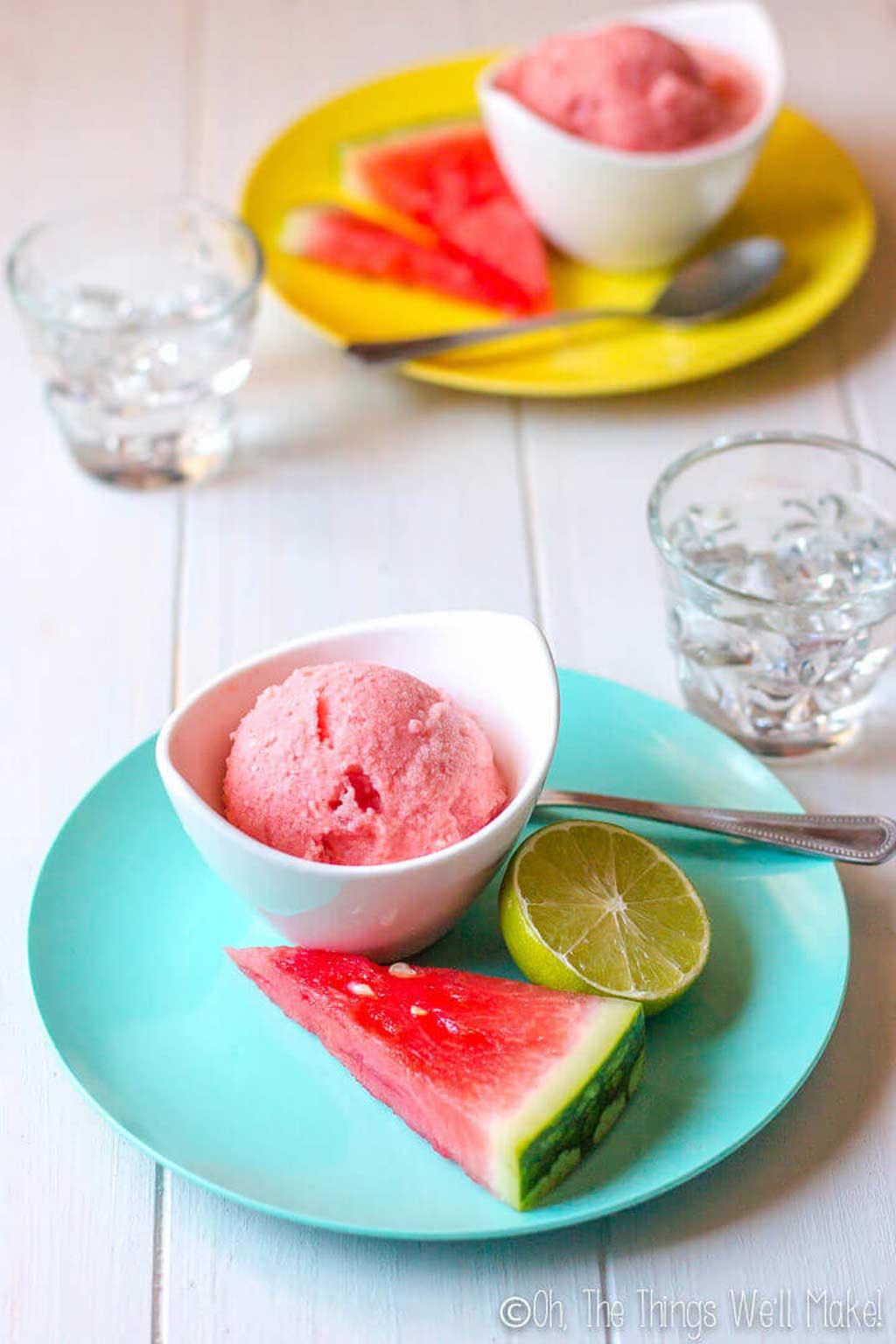 watermelon ice cream in a bowl with a slice of watermelon and lime beside it