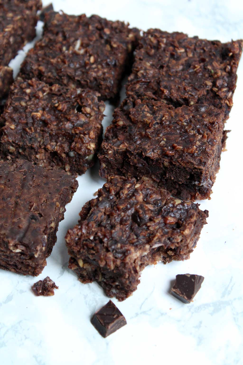 squares of black bean brownies. One has a bite out of it.