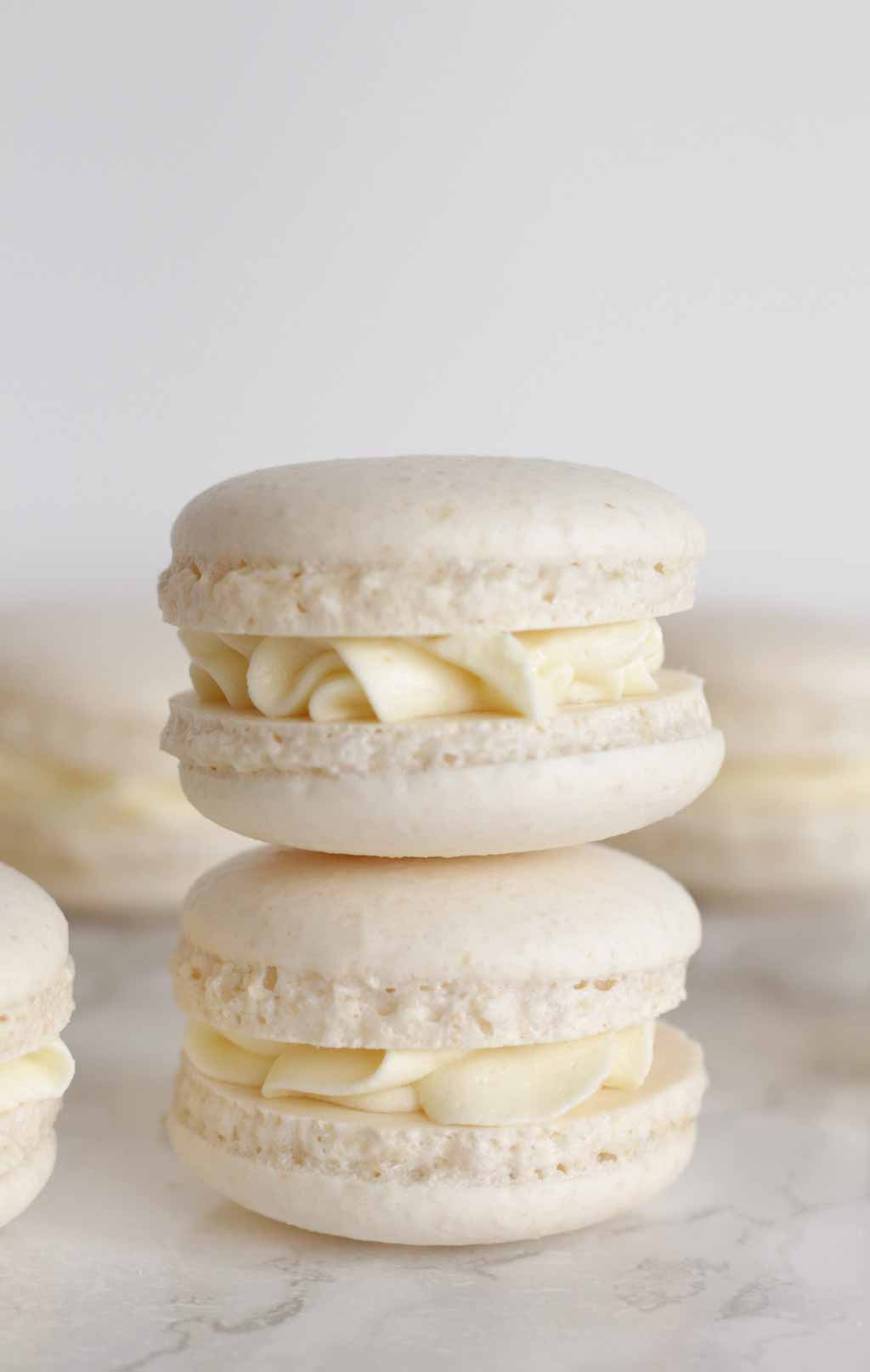 Two White Macarons Stacked On Top Of One Another