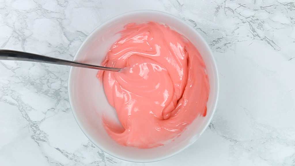 Pink icing in a bowl