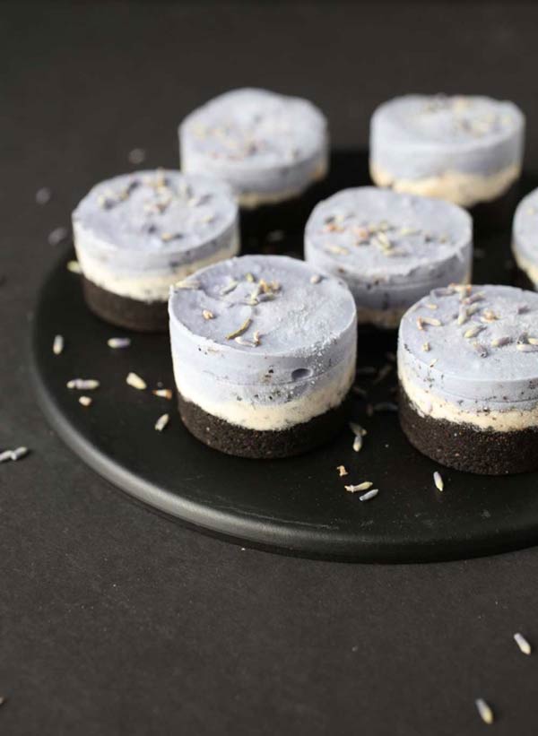 6 mini purple cheesecakes on a black plate