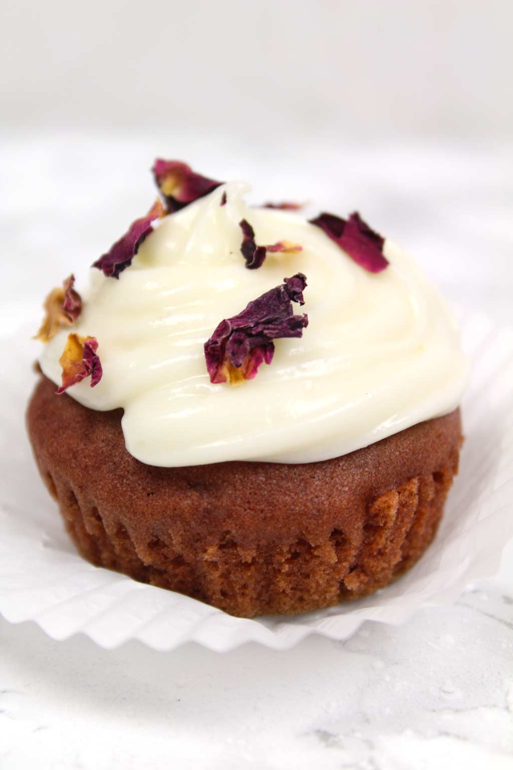 a single vegan red velvet cupcake with cream cheese frosting