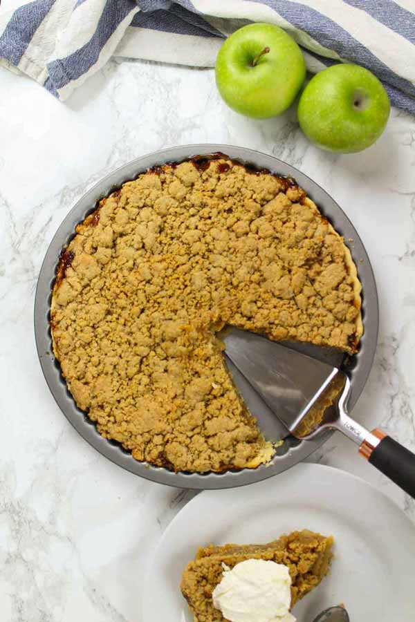 Vegan Dutch Apple Pie With A Slice Taken Out Of It