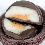 two halves of a vegan Creme Egg with the fondant in the center showing