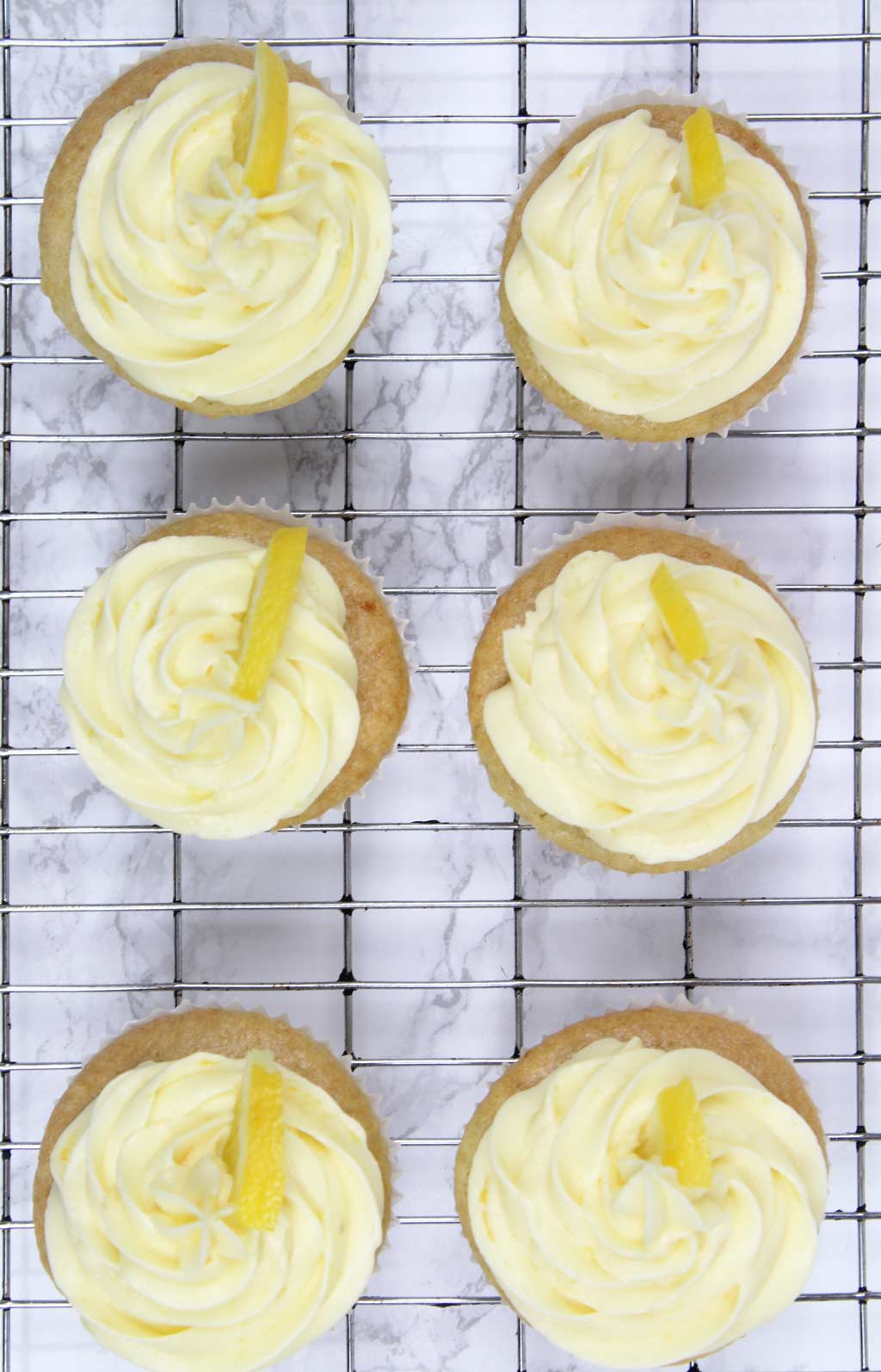 overhead shot of 6 frosted cupcakes on a wire rack