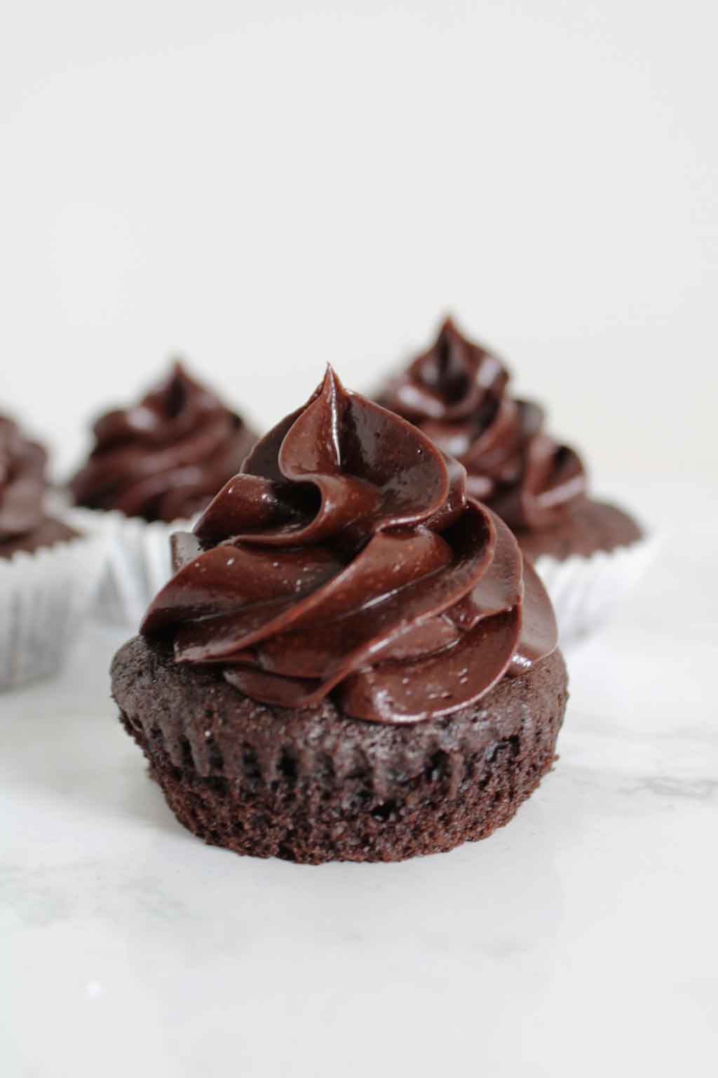 Chocolate Cupcake with chocolate frosting, taken out of the paper case