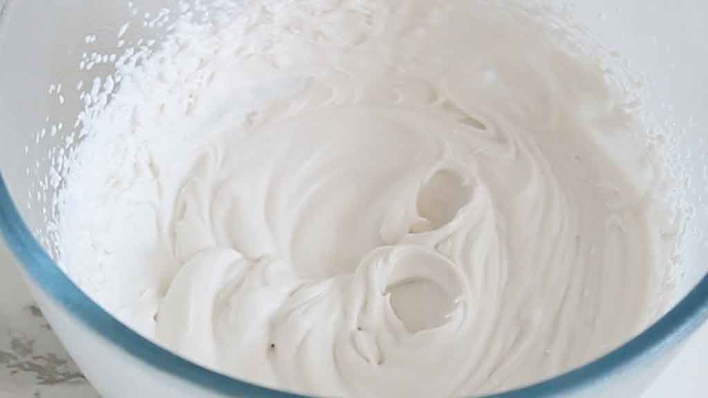 vegan coconut whipped cream in a bowl holding stiff peaks