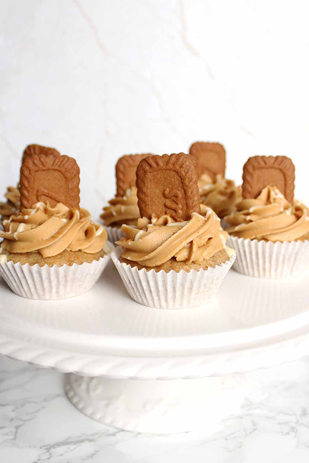 Six Biscoff Cupcakes On A White Cake Stand