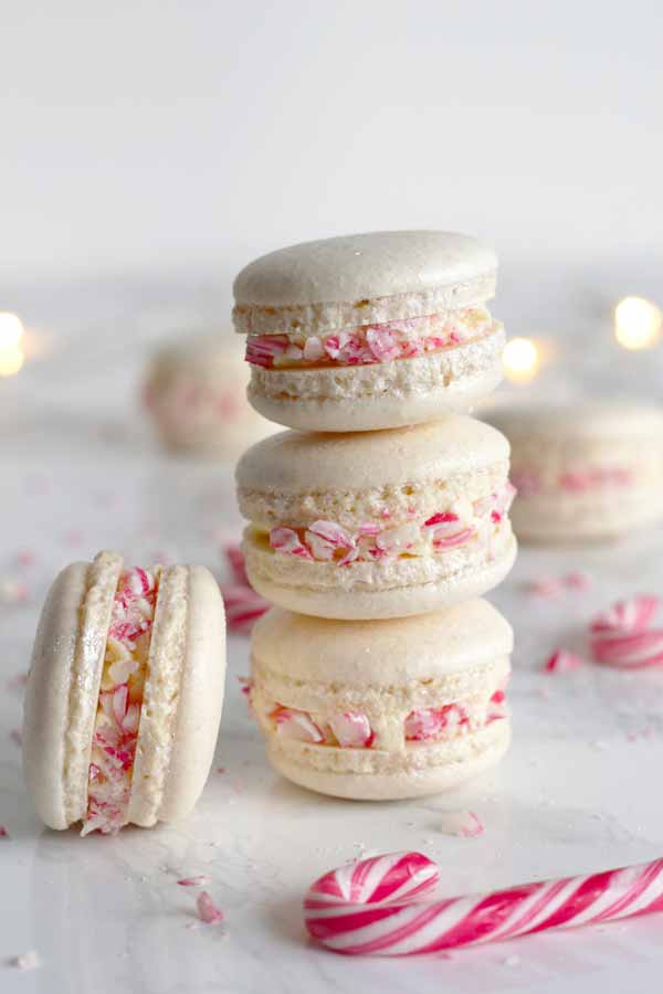 stack of 3 candy cane macarons with one side-facing macaron beside the stack