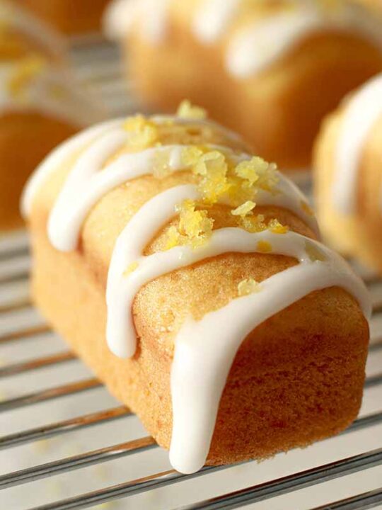 vegan mini lemon loaf cakes sitting on a wire rack