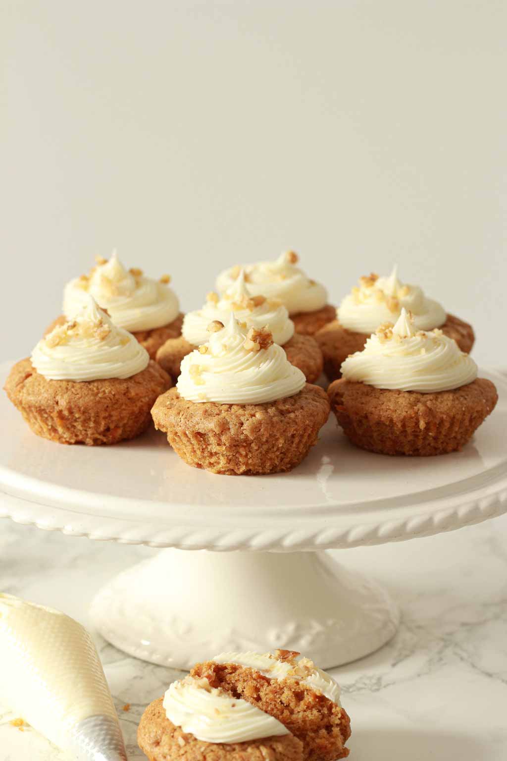 Vegan Carrot Cupcakes On A White Cake Stand