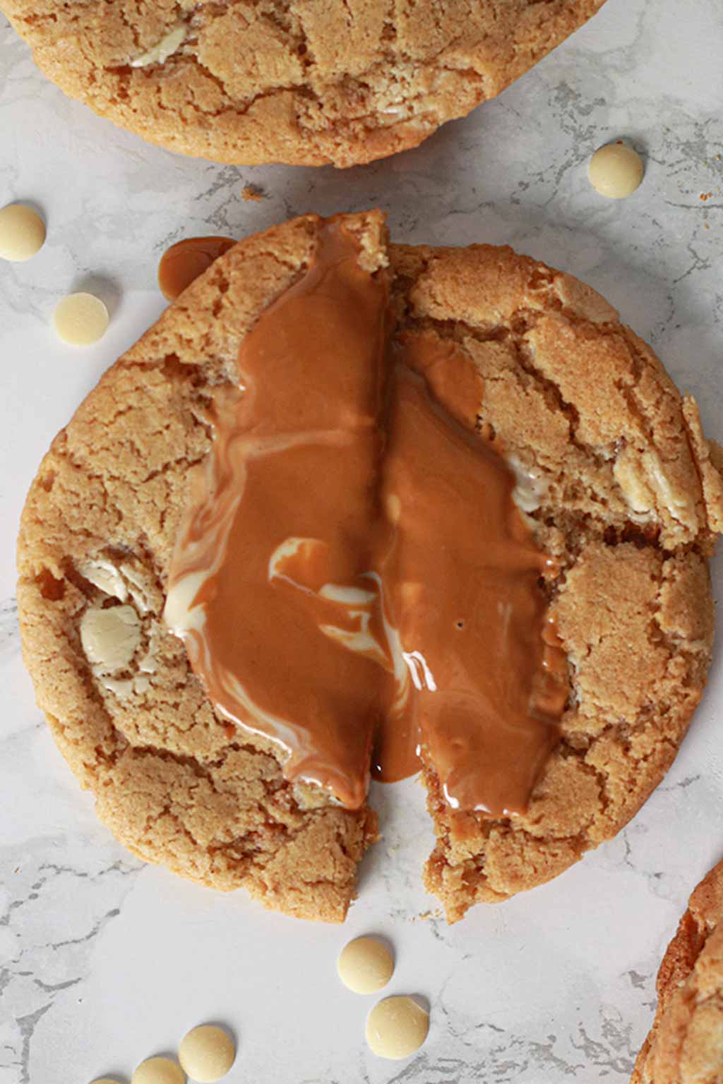 cookie snapped in half with melted biscoff filling showing