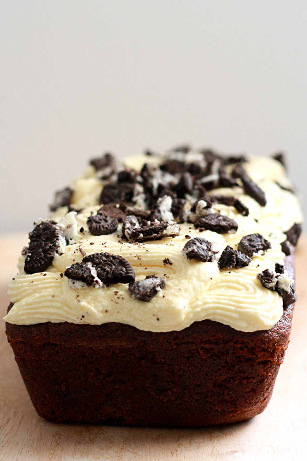 chocolate loaf cake with icing and crushed Oreo cookies on top