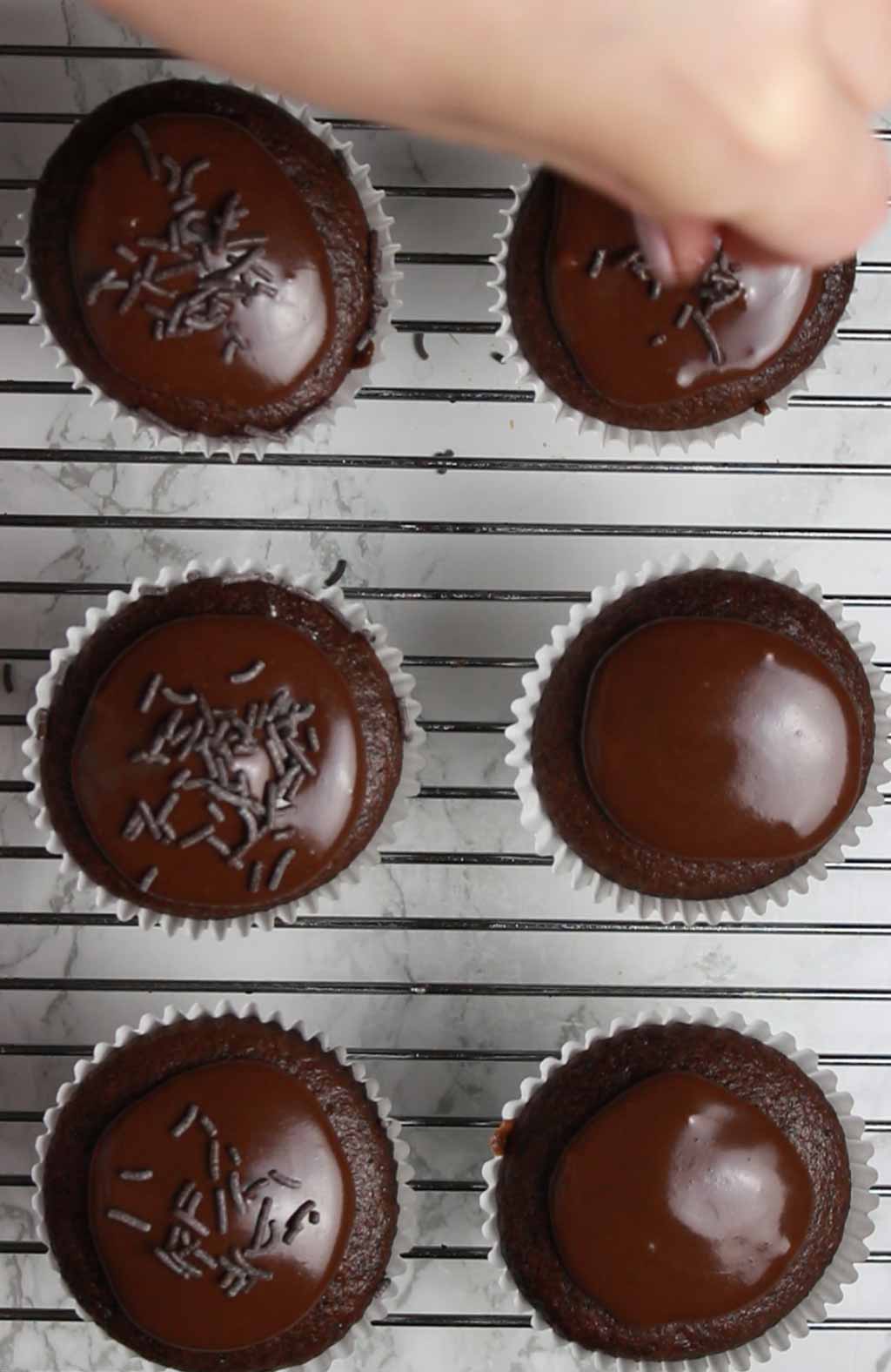 Adding Chocolate Sprinkles To The Fairy Cakes