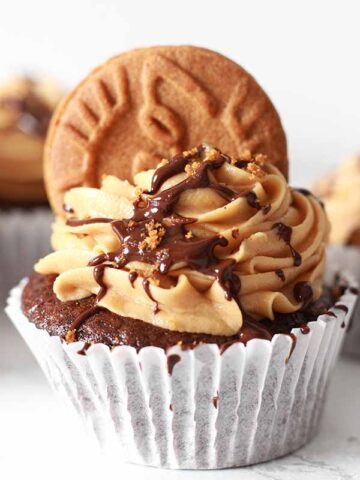 chocolate cupcake topped with Biscoff icing and chocolate sauce