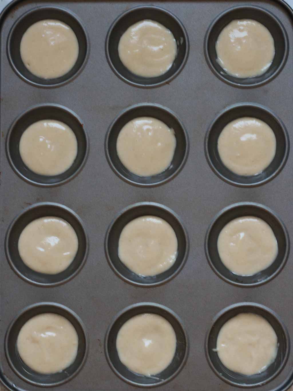 A Cupcake Tin Filled With A Small Amount Of Cake Batter