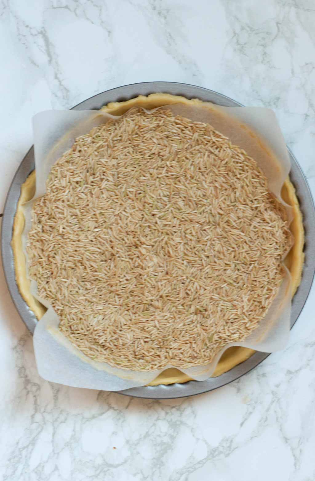 Dough In Tin With Baking Paper And Rice On Top