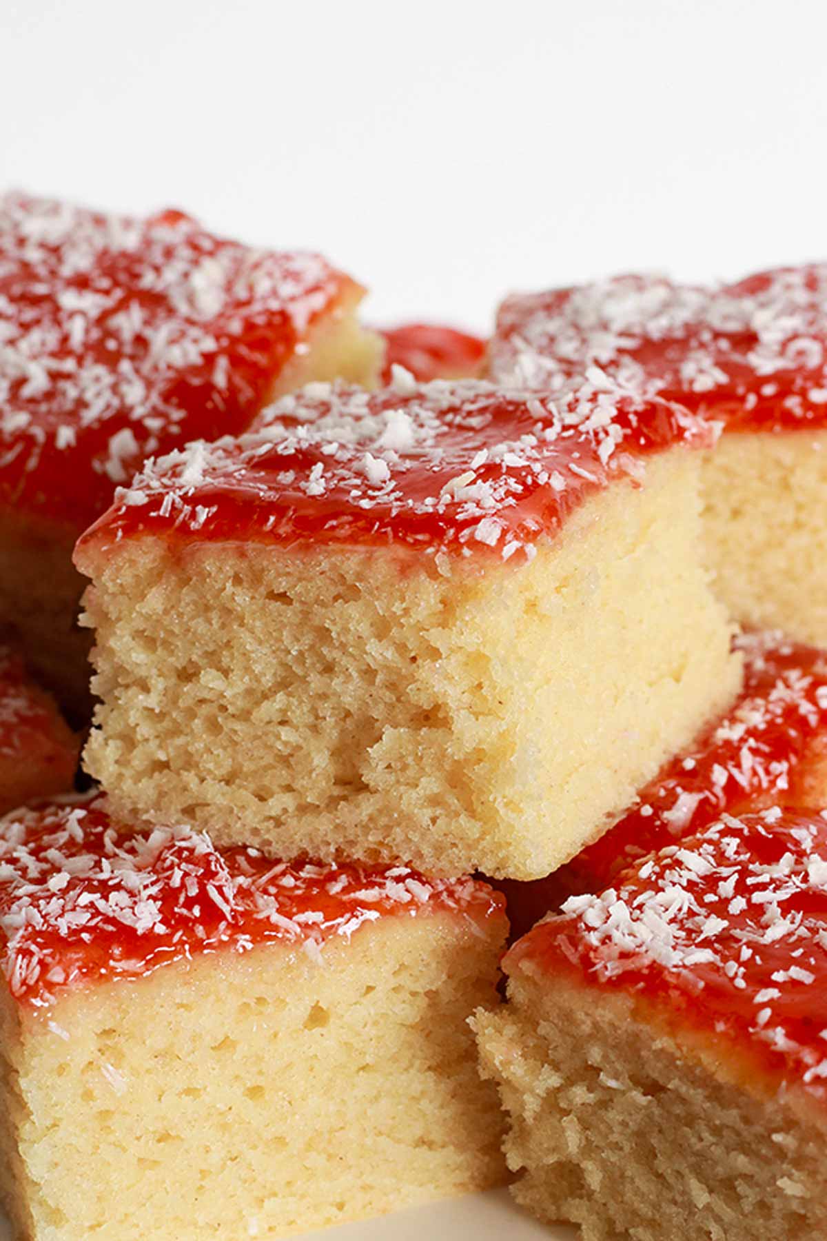 Square Slices Of Vegan Jam And Coconut Sponge