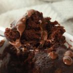 image of a spoonful of chocolate cake being taken out of the mug