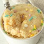 Vanilla Mug Cake With Spoonful Taken Out Of It