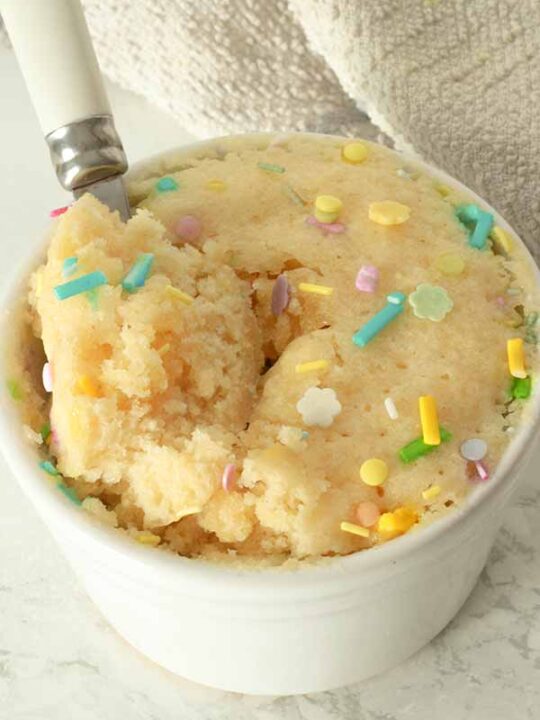 Vanilla Mug Cake With Spoonful Taken Out Of It