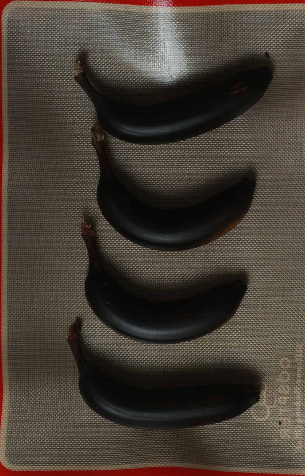 Black Baked Bananas On A Silicone Sheet