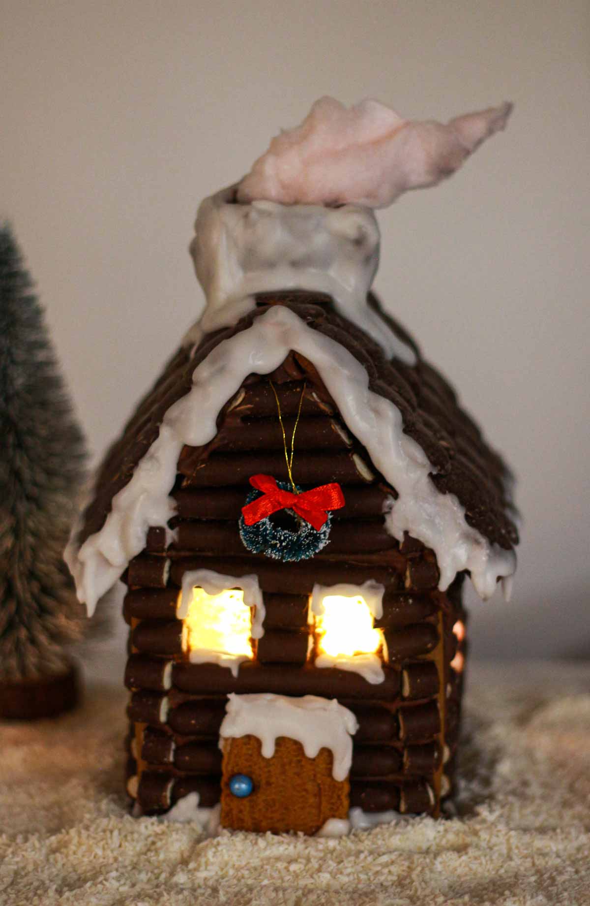 Edible gingerbread House With Light Shining Through Windows