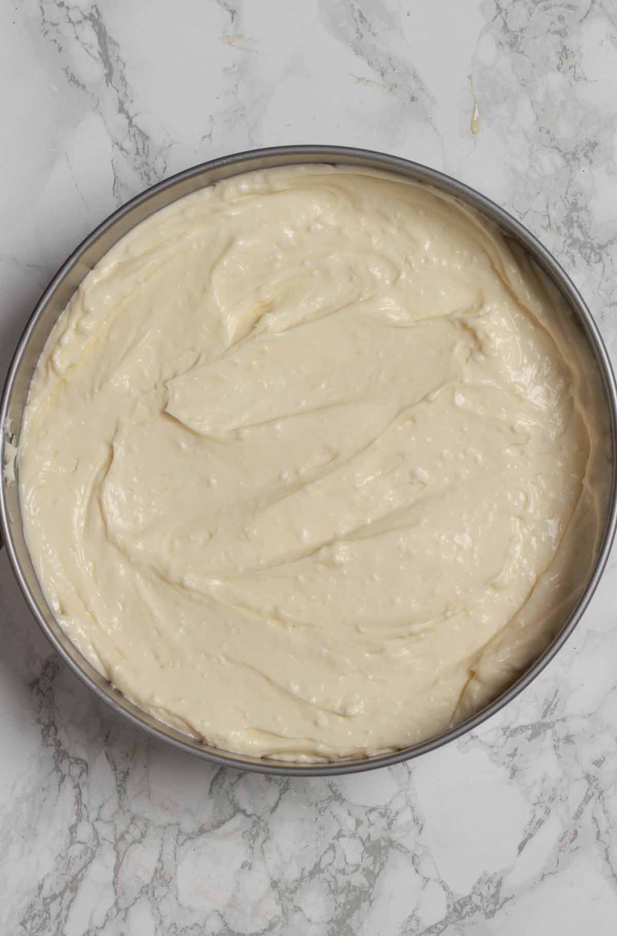 White Chocolate Filling Spread Over Base In The Tin