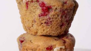 2 Vegan Raspberry White Choc Muffins Stacked On Top Of One Another