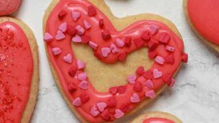 Vegan valentine heart shaped cookies on a white surface