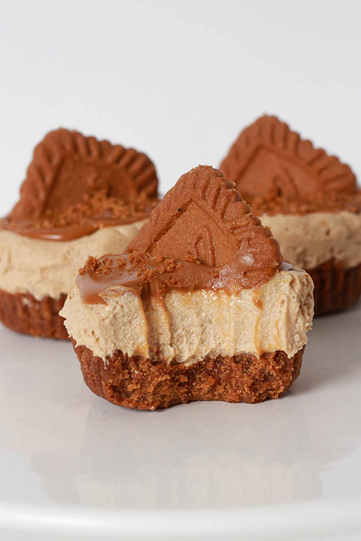 3 Mini Biscoff Cheesecakes On A White Cake Stand