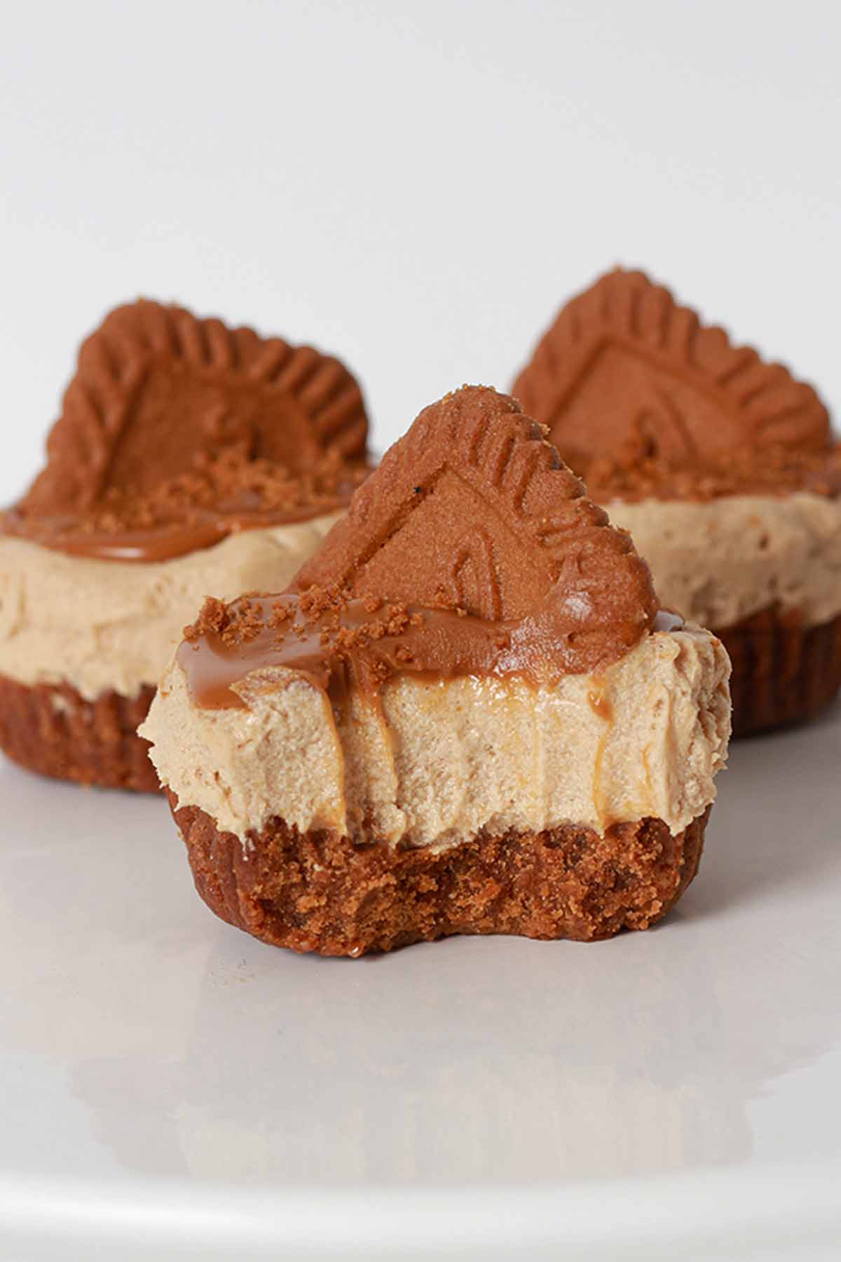 3 Mini Biscoff Dairy-free Cheesecakes On A White Cake Stand