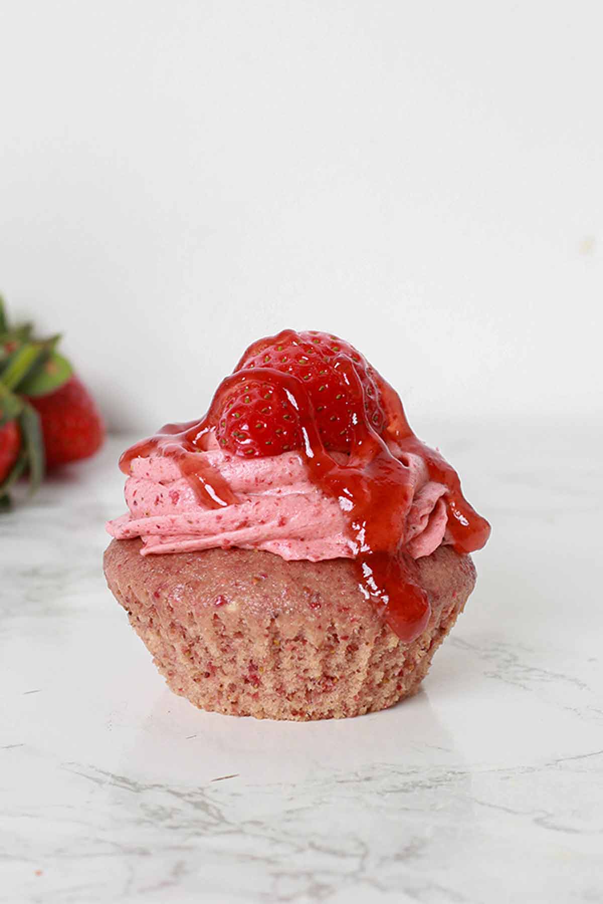 Single Strawberry Cupcake on a white surface