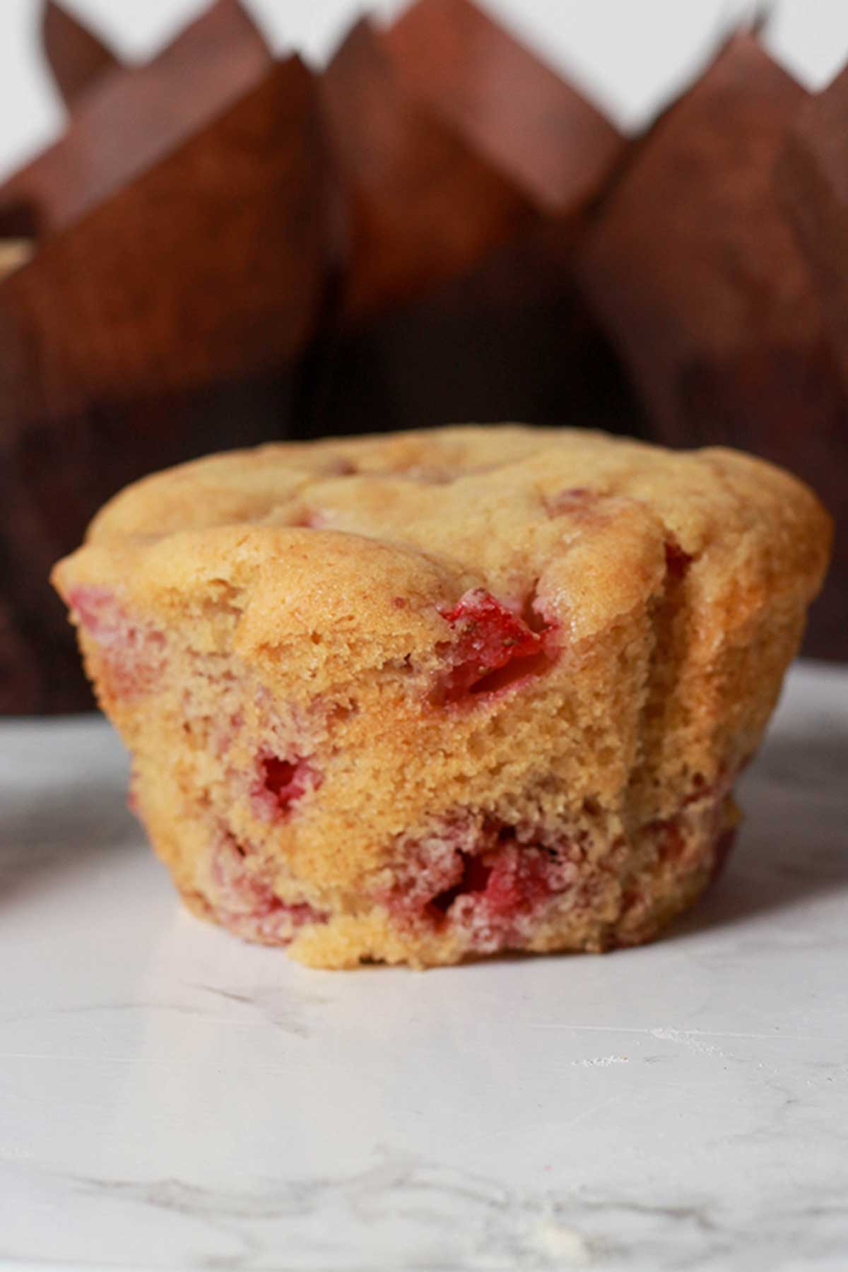 A Strawberry Muffin With The Wrapper Taken Off