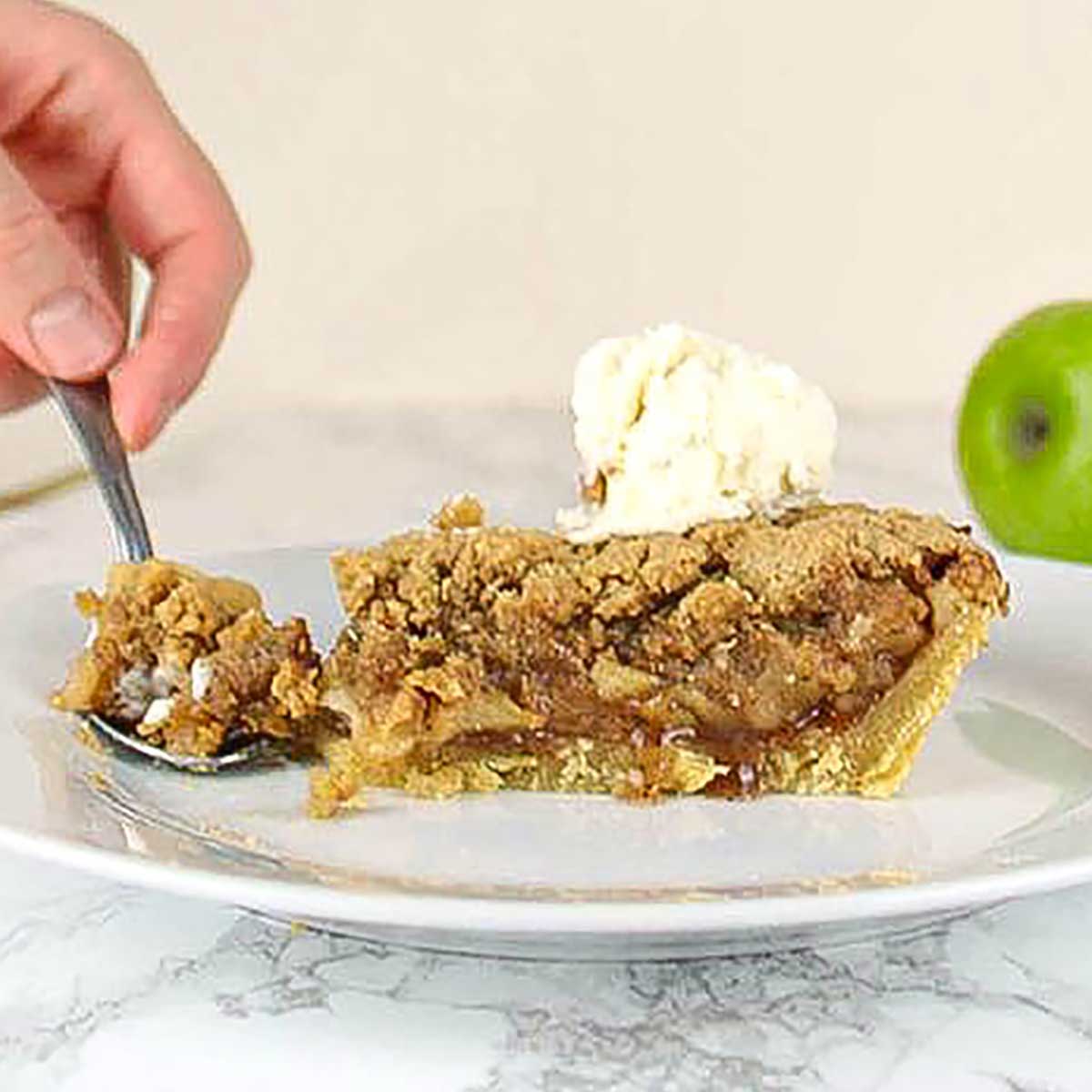 Slice Of Dairy Free Apple Crumble Pie On A Plate