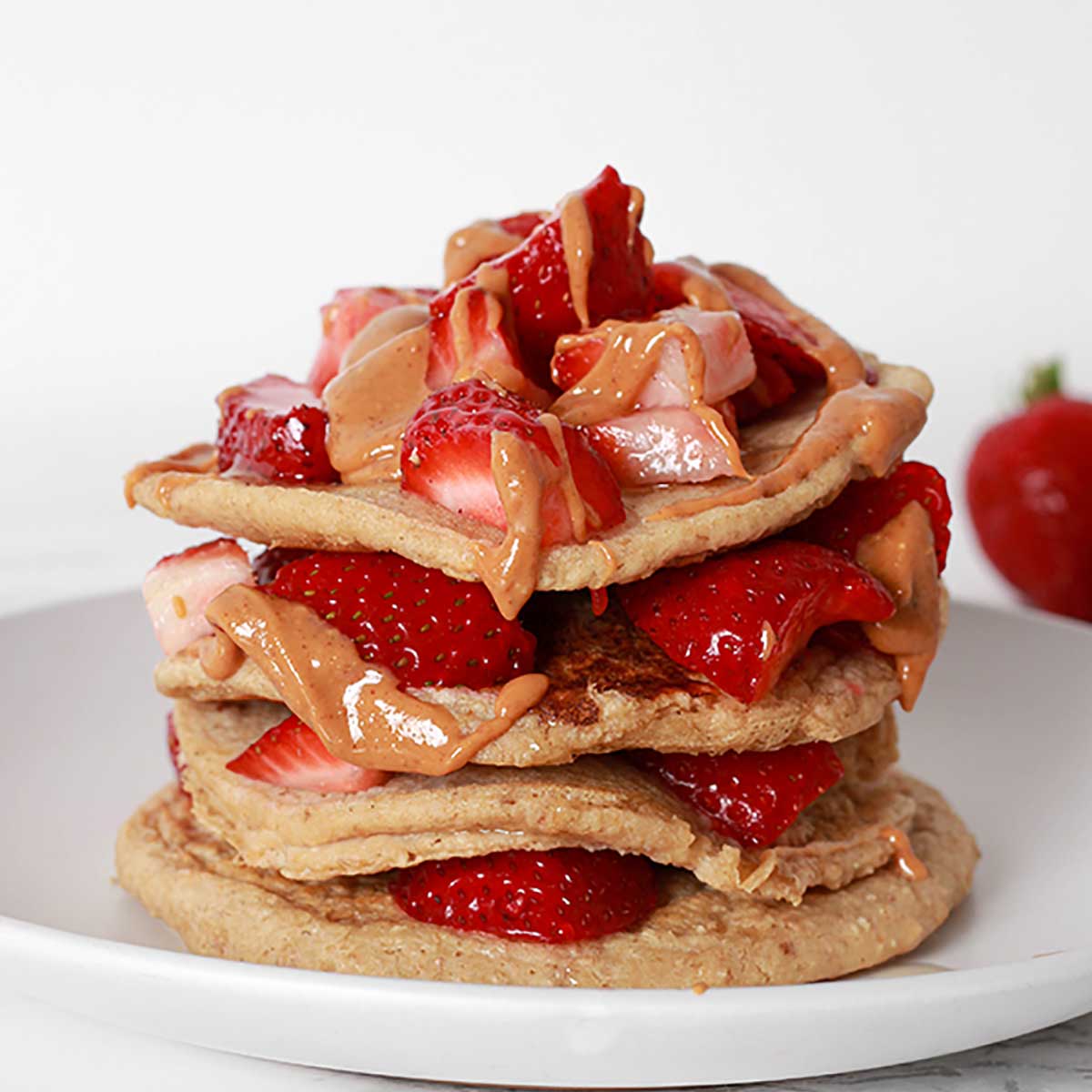 Stack Of Vegan Pancakes With Strawberries And Peanut Butter2