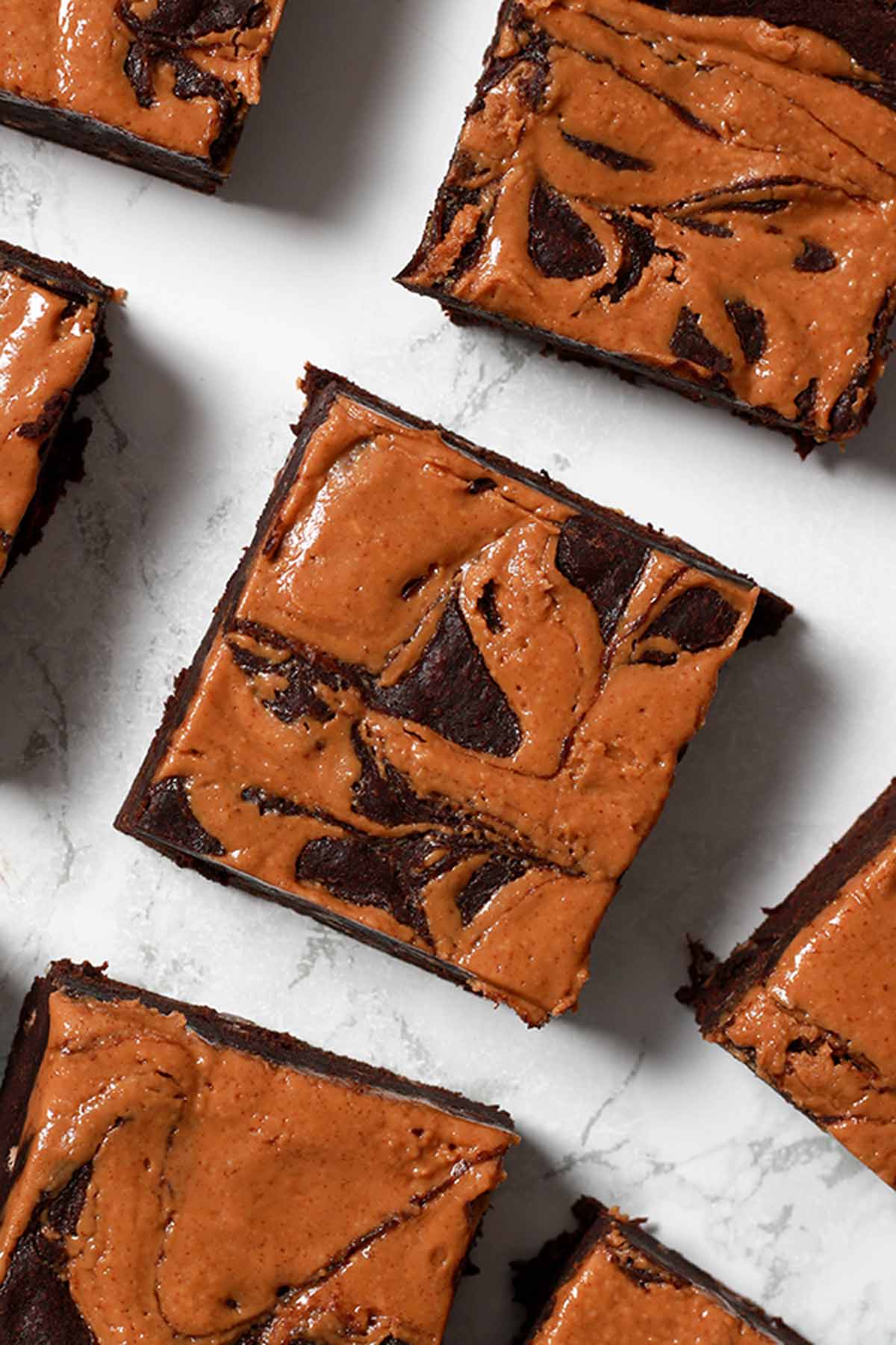 Eggless Peanut Butter Brownies Lying On A White Surface