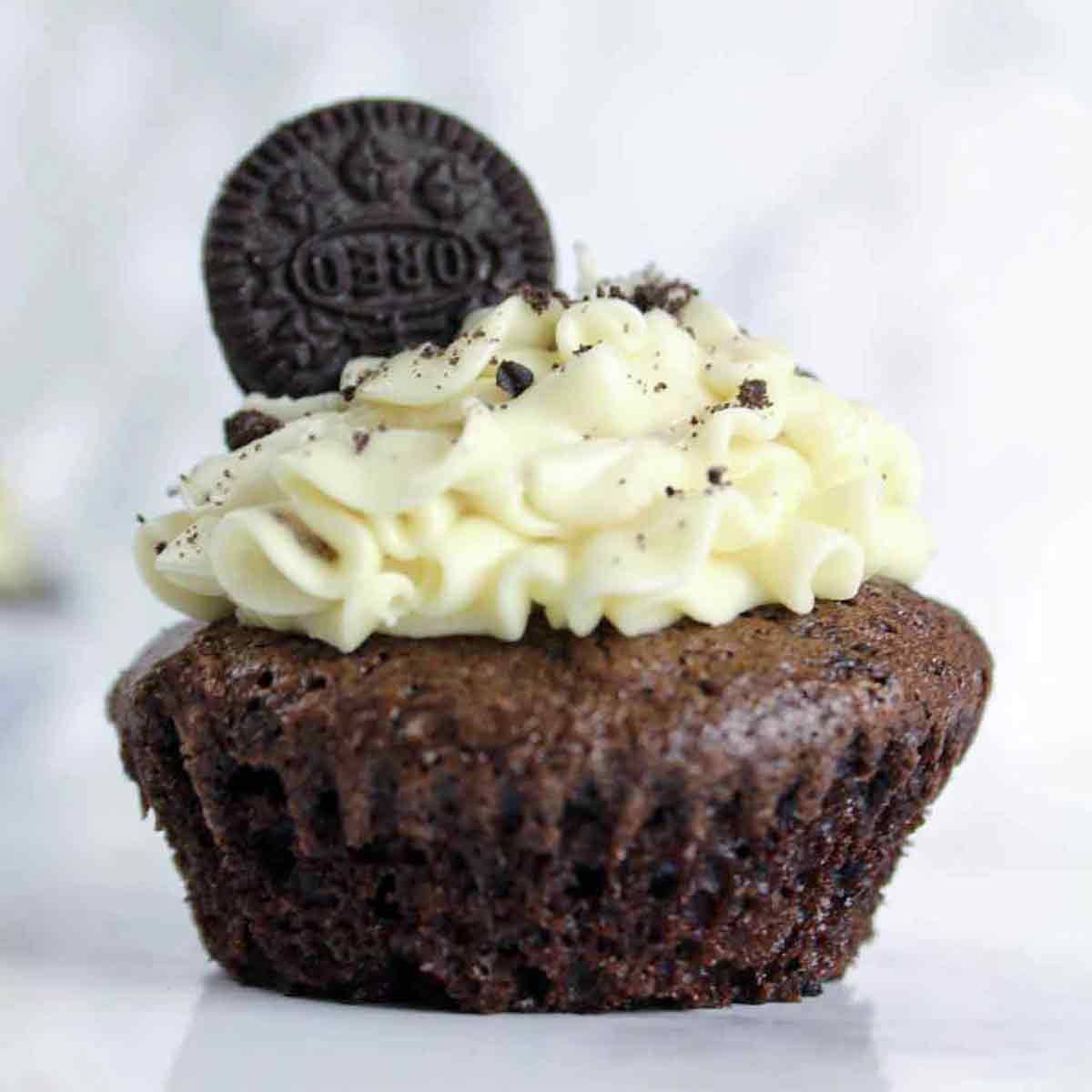 A Vegan Oreo Cupcake With Frosting On Top