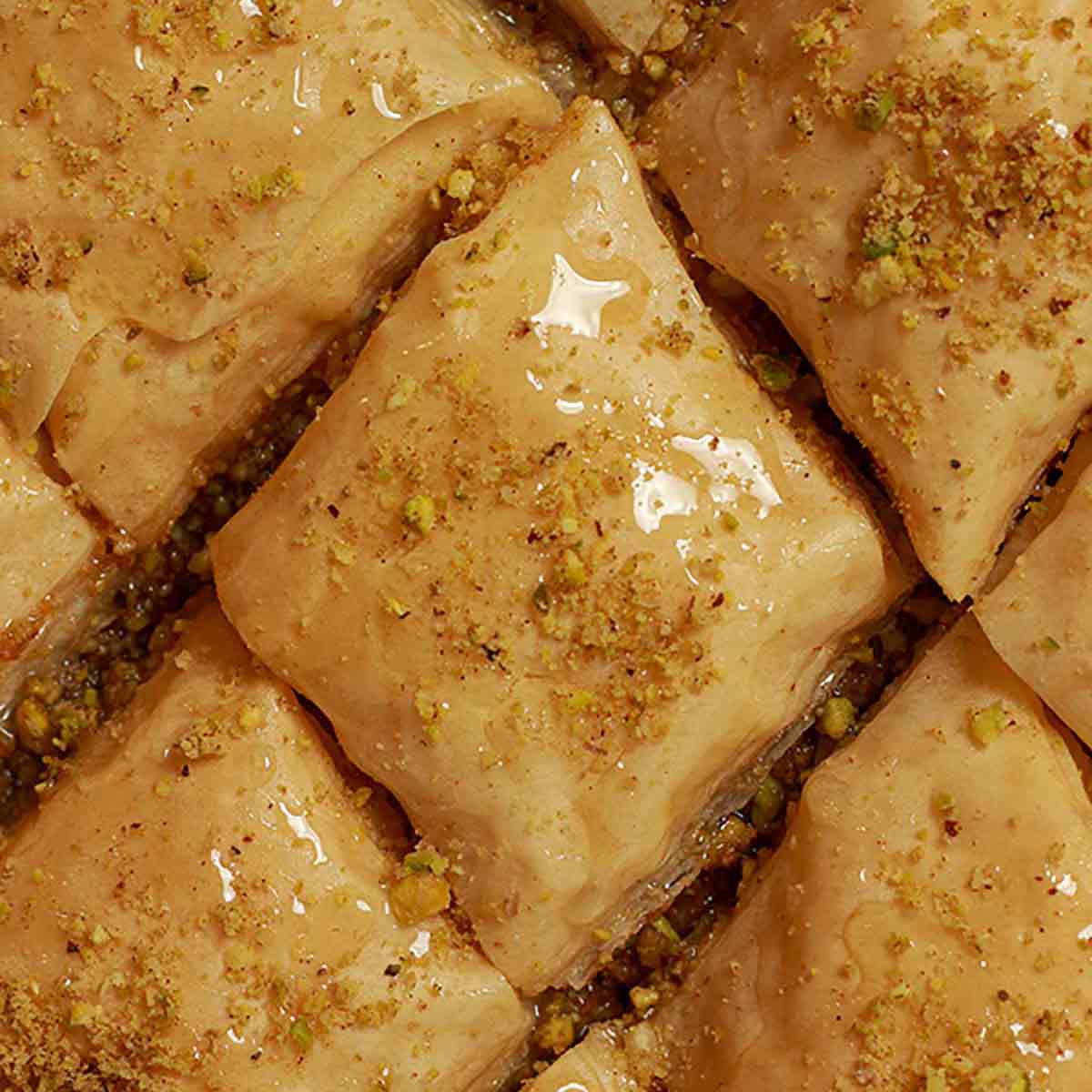 Close Up Of Baklava In Tray With Syrup Poured On Top