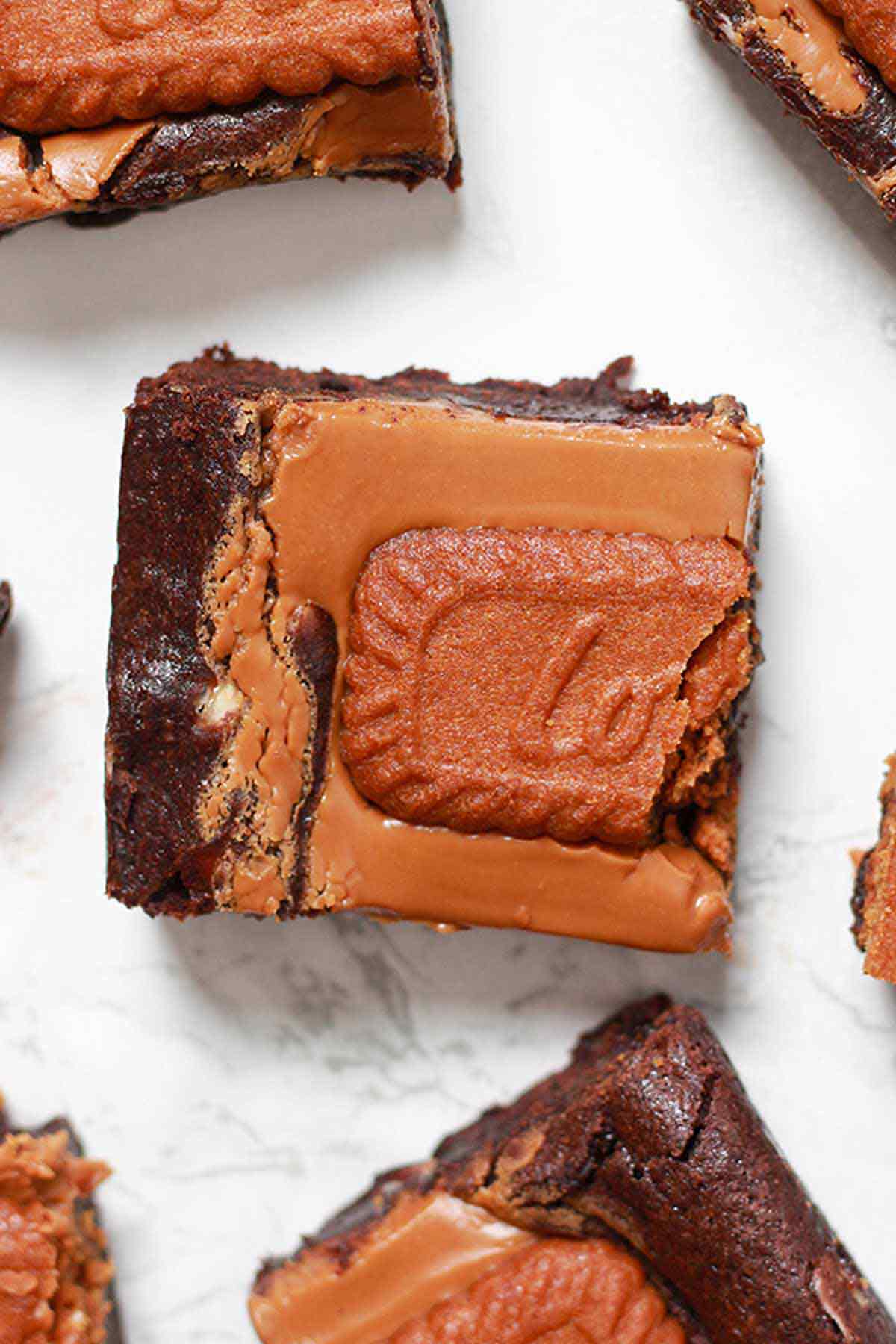 Overhead Shot Of Vegan Biscoff Brownies On A White Surface