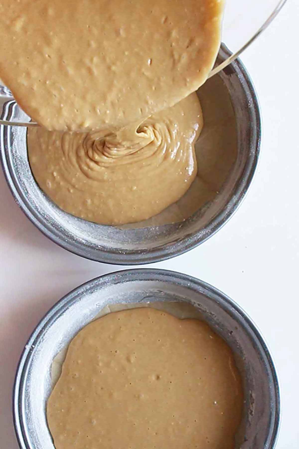 Pouring Dairy Free Coffee Batter Into Cake Tins