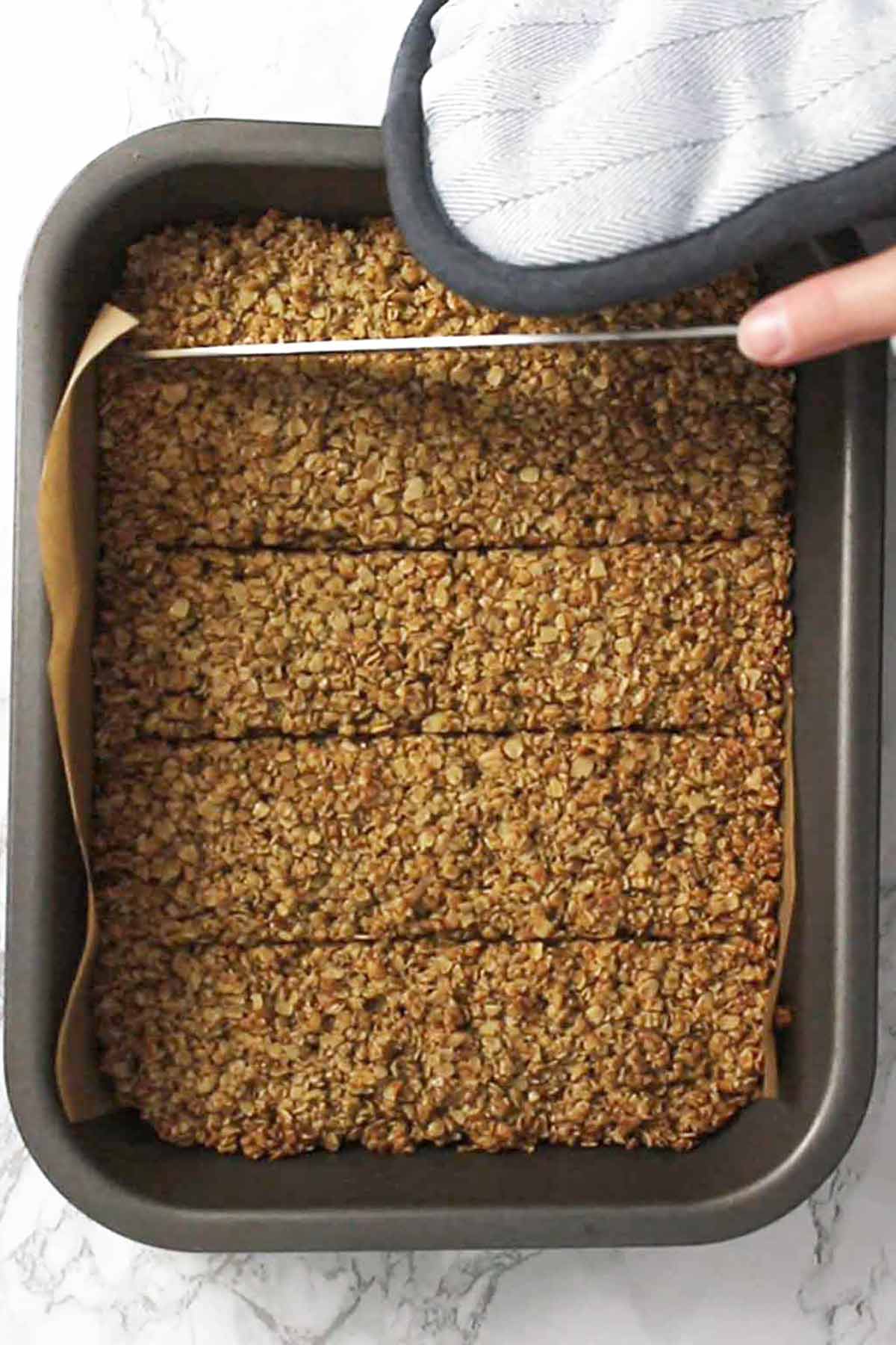 Scoring The Baked Flapjacks In The Tin