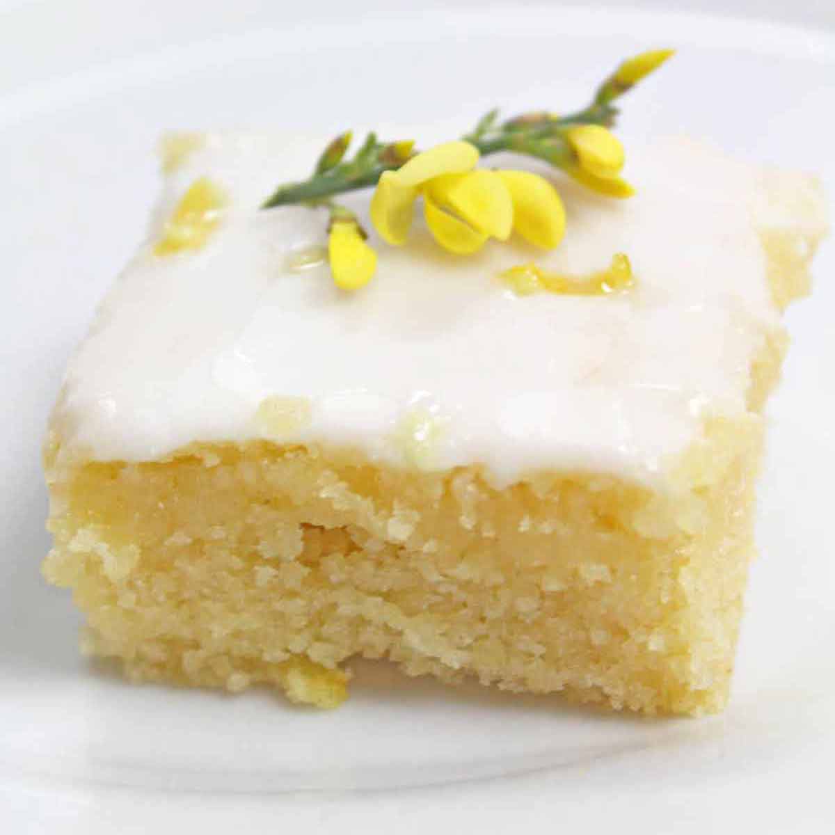 Slice Of Eggless Lemon Drizzle Cake On A Plate