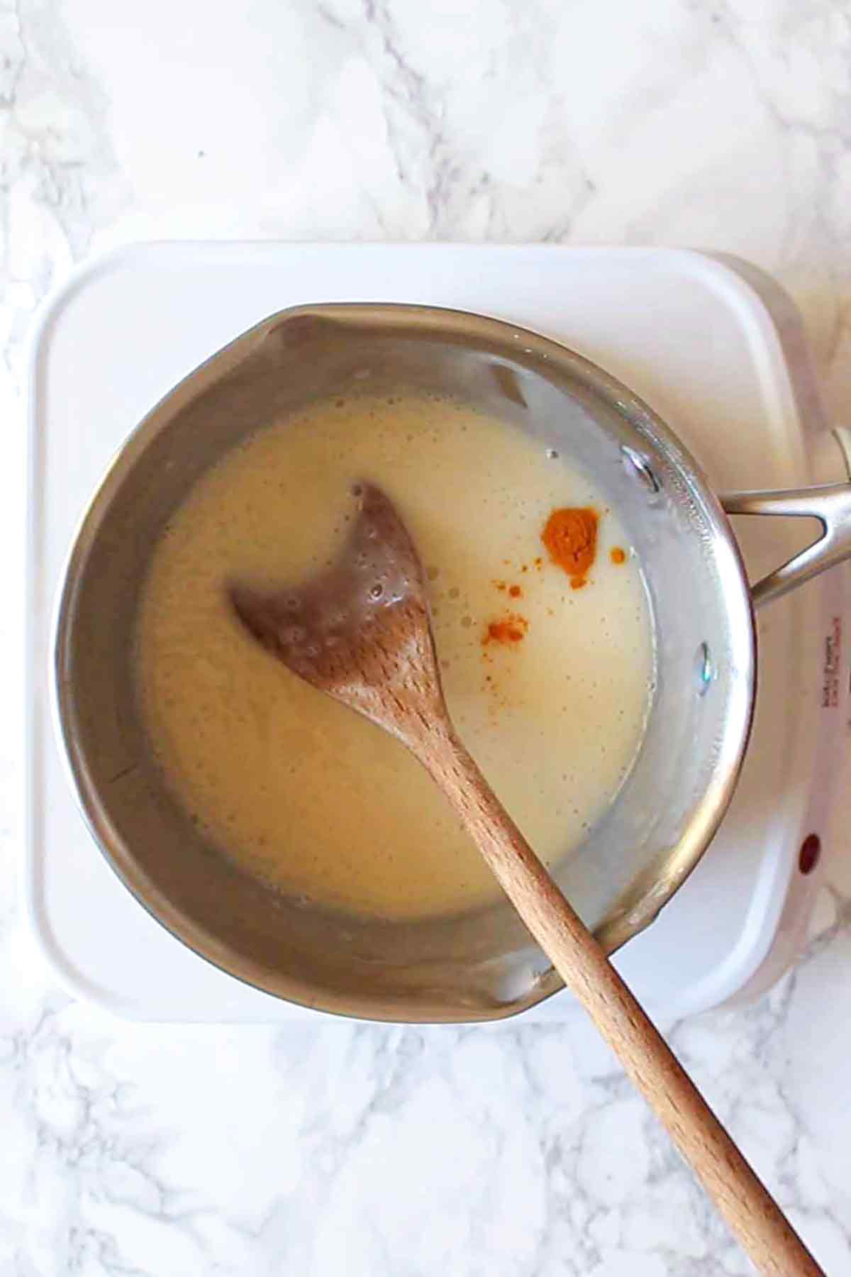 adding turmeric to the pot