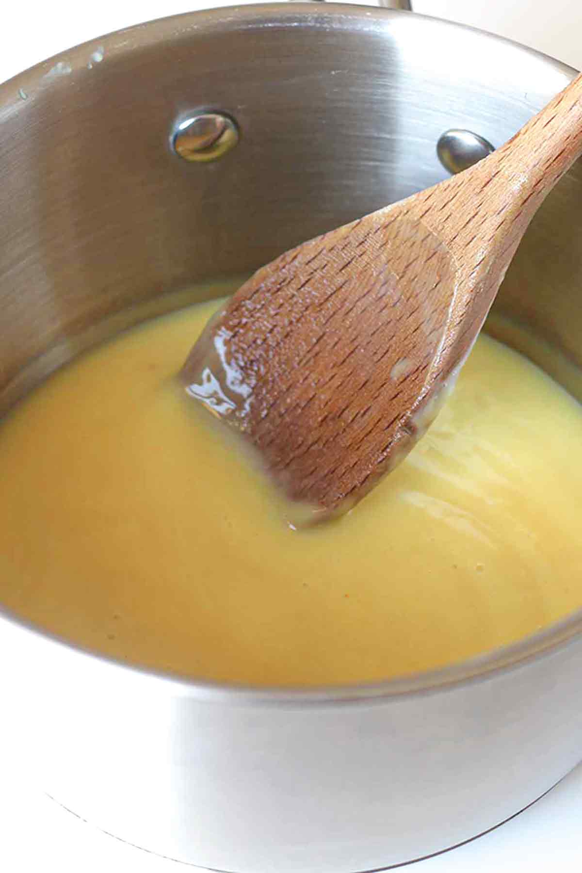 Wooden Spoon In A Pot Of Custard